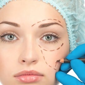 A woman with cosmetic surgery markings on her face.