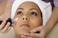 Woman receiving a facial treatment with a skincare device.